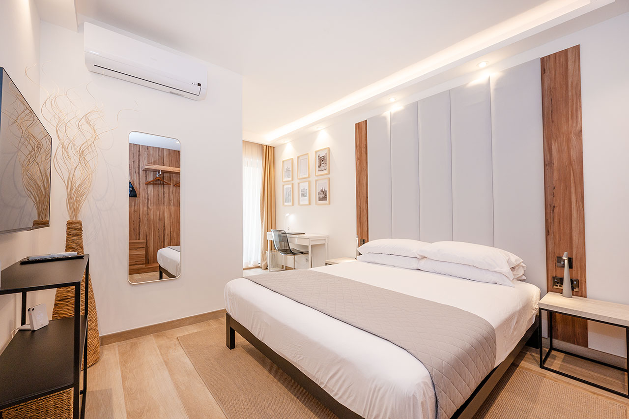 Guest bedroom with desk and Malta artwork